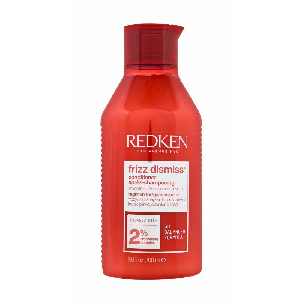 Flacone rosso Redken Frizz Dismiss Conditioner. Etichetta bianca con nome e informazioni. 2% Smoothing Complex.
