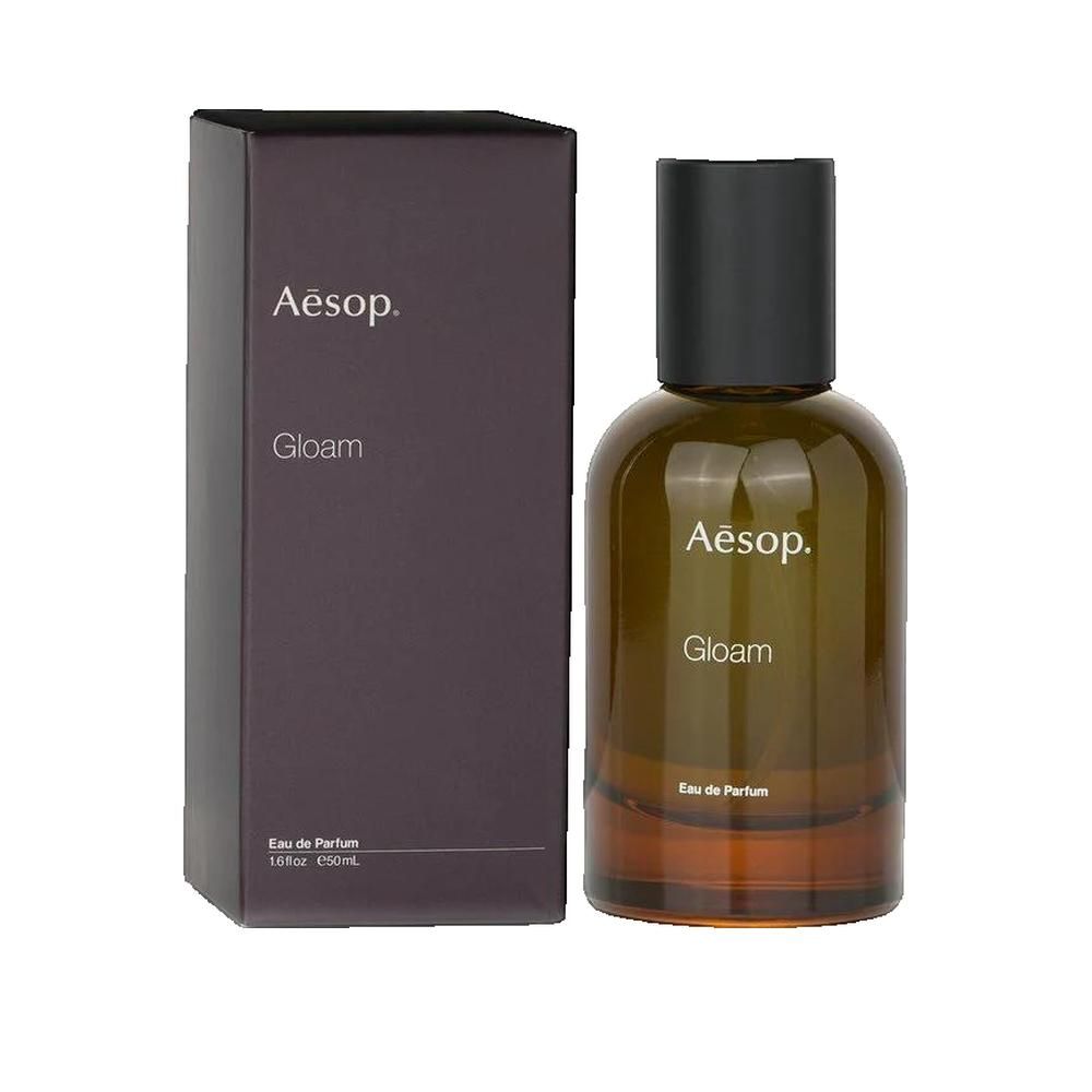 Flacone in vetro marrone con tappo nero e confezione. Logo Clarins e scritta Gloam.