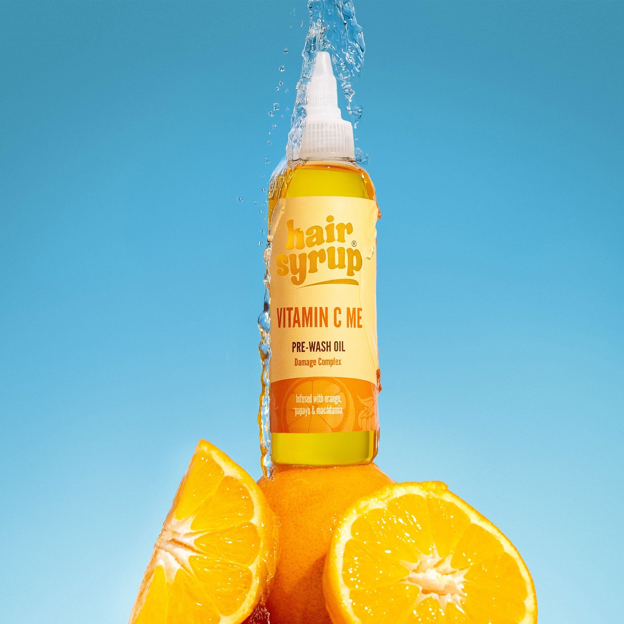Flacone giallo "Hair Syrup Vitamin C Me". Arance e getto d'acqua. Pre-Wash Oil.