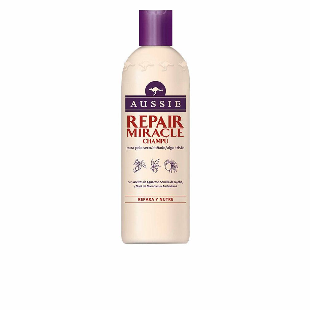 Flacone di shampoo beige con tappo viola. Scritta: Aussie Repair Miracle Champú. Logo canguro.