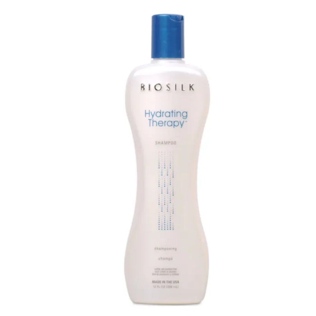 Flacone bianco con tappo blu. Scritta: Biosilk Hydrating Therapy Shampoo. Forma verticale, parte centrale stretta.