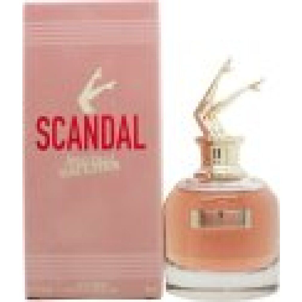 Flacone di profumo con tappo a forma di gambe dorate e confezione rosa. Scritta "SCANDAL" e "Jean Paul Gaultier".