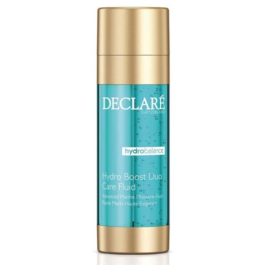 Flacone cilindrico con tappo e base dorati. Contenuto turchese. Scritte: DECLARE, hydrobalance, Hydro Boost Duo Care Fluid.