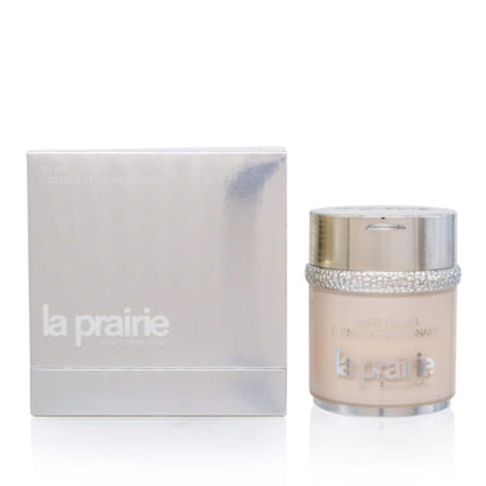 Vaso di crema accanto a una scatola argentata. Scritta: White Caviar Crème Extraordinaire, La Prairie.