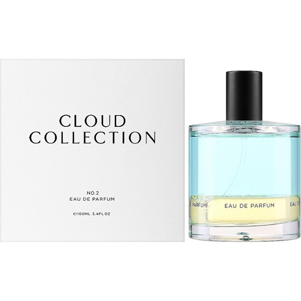 Flacone di profumo con liquido azzurro e giallo, accanto a scatola bianca con scritta "CLOUD COLLECTION".