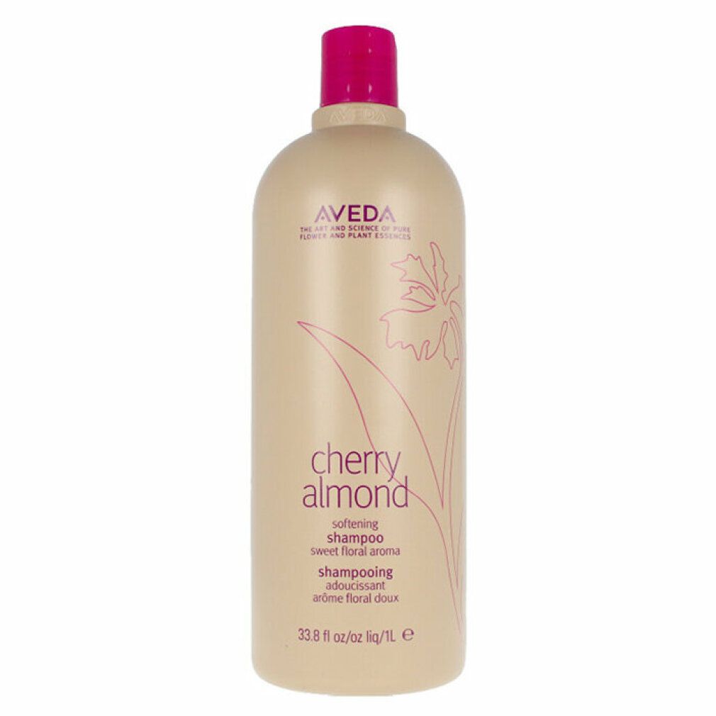 Flacone di shampoo beige con tappo rosa. Scritta: Aveda, Cherry Almond, Shampoo. Design floreale.