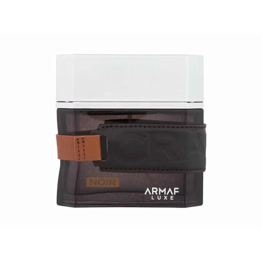 Flacone nero con cinturino in pelle marrone e tappo argentato. Scritta: Noir, Armaf Luxe.
