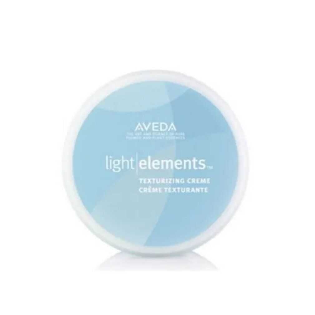 Contenitore rotondo blu con coperchio bianco. Scritta: Aveda light elements. Crema texturizzante. Crème texturisante.