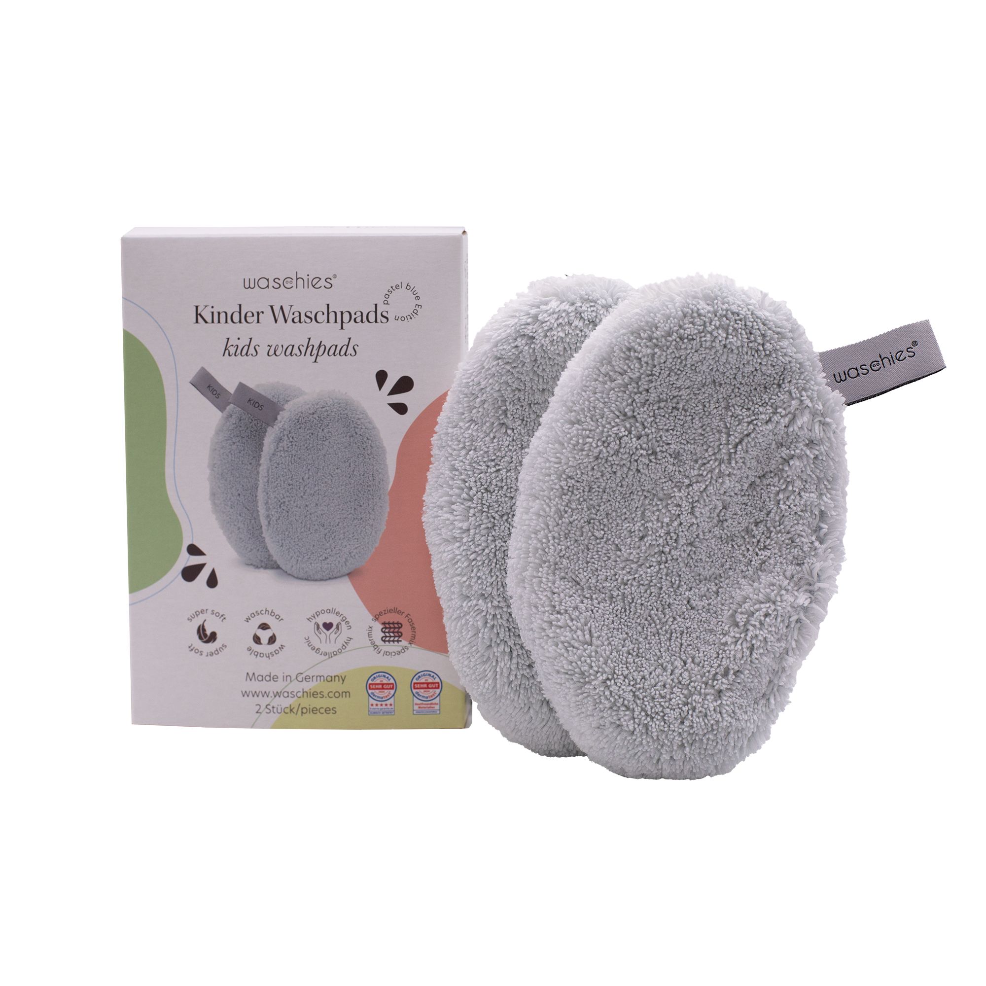 Due dischetti lavabili grigi con etichette "KIDS" accanto a una confezione. Sulla confezione c'è scritto "waschies Kinder Washpads".