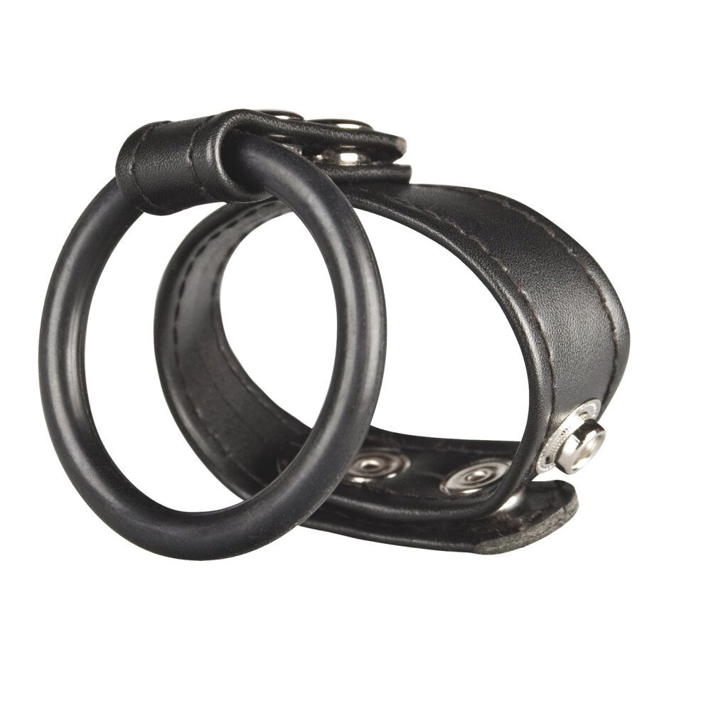 Anello pene e testicoli nero in pelle e gomma con bottoni a pressione.