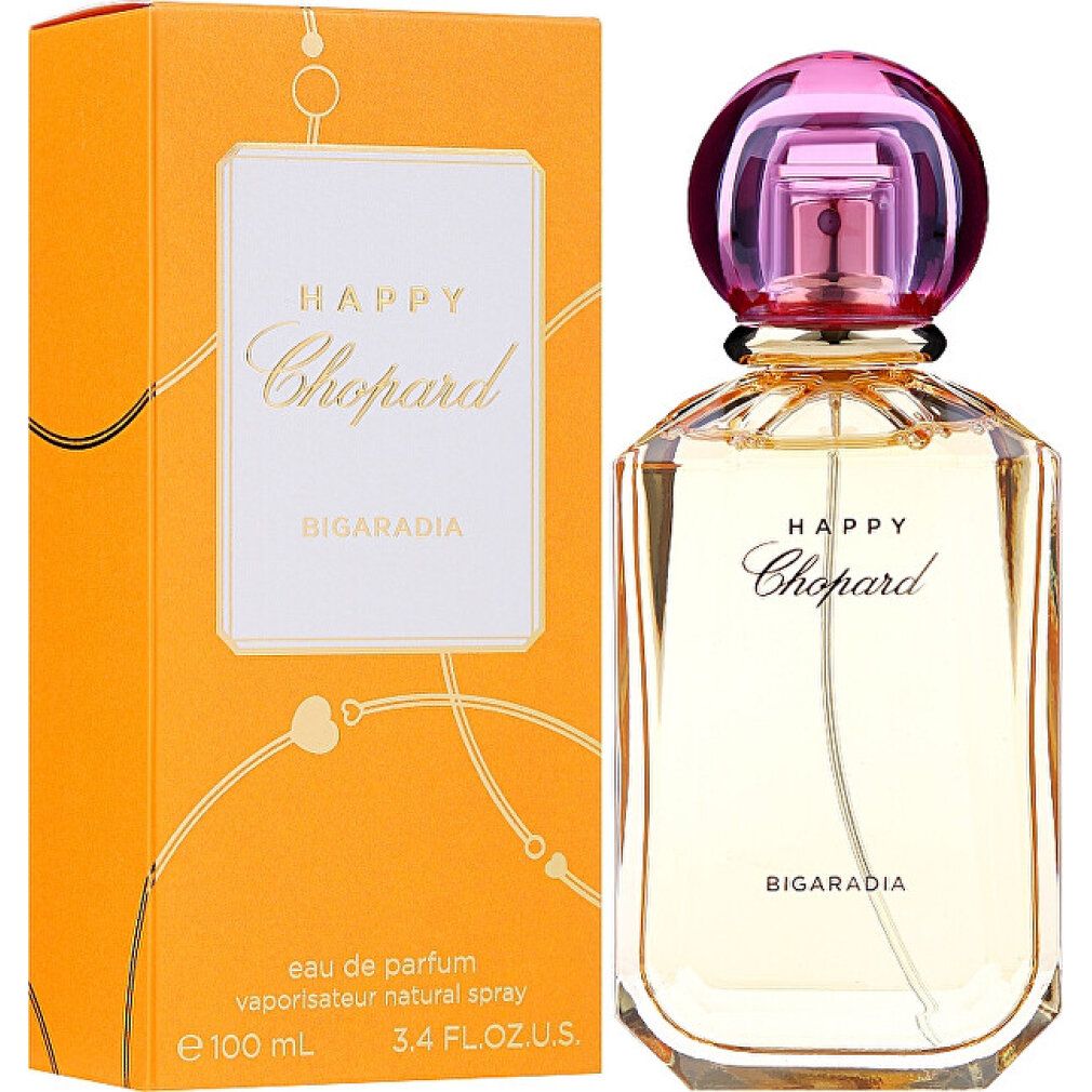 Flacone di profumo e confezione. Flacone con tappo rosa, vetro dorato. Confezione arancione con etichetta bianca e scritta Happy Chopard.