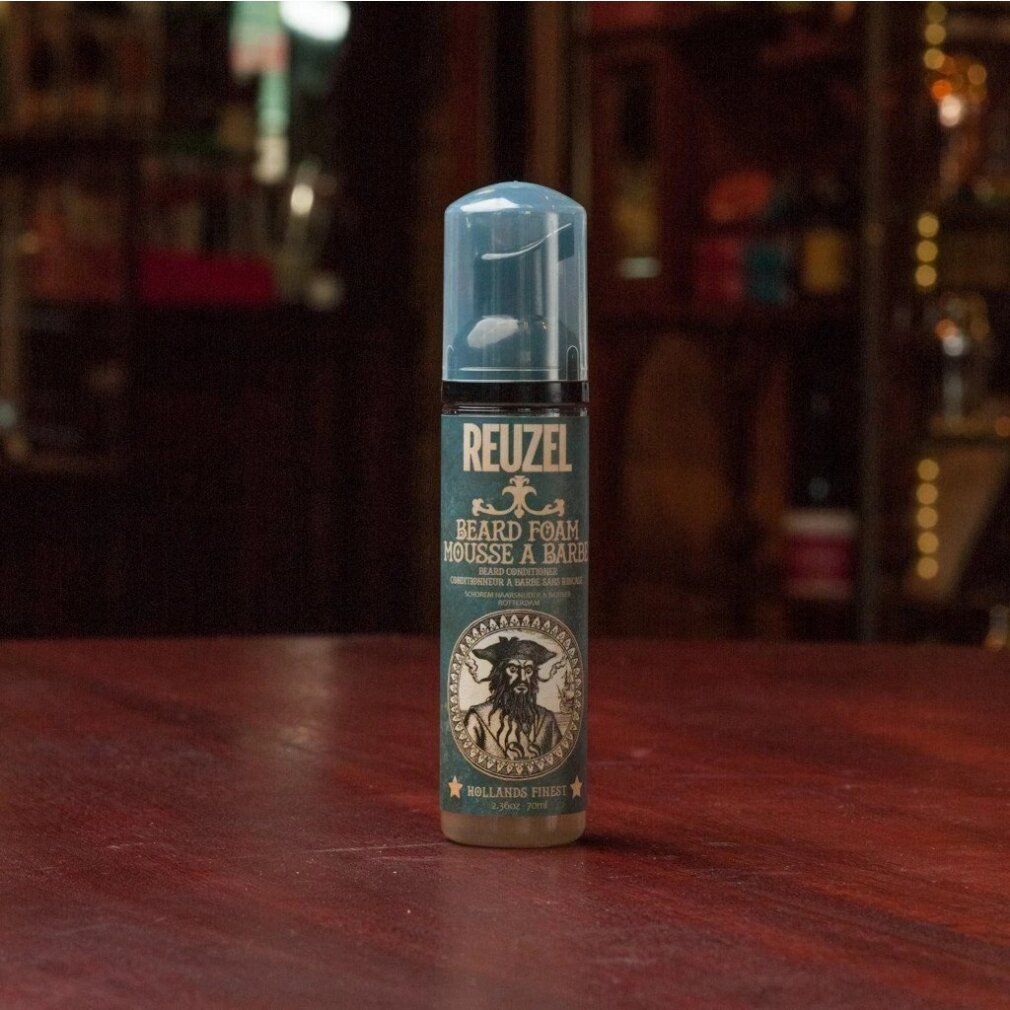 Flacone di schiuma per barba Reuzel con erogatore blu. Illustrazione uomo barbuto. Testo: Hollands Finest.