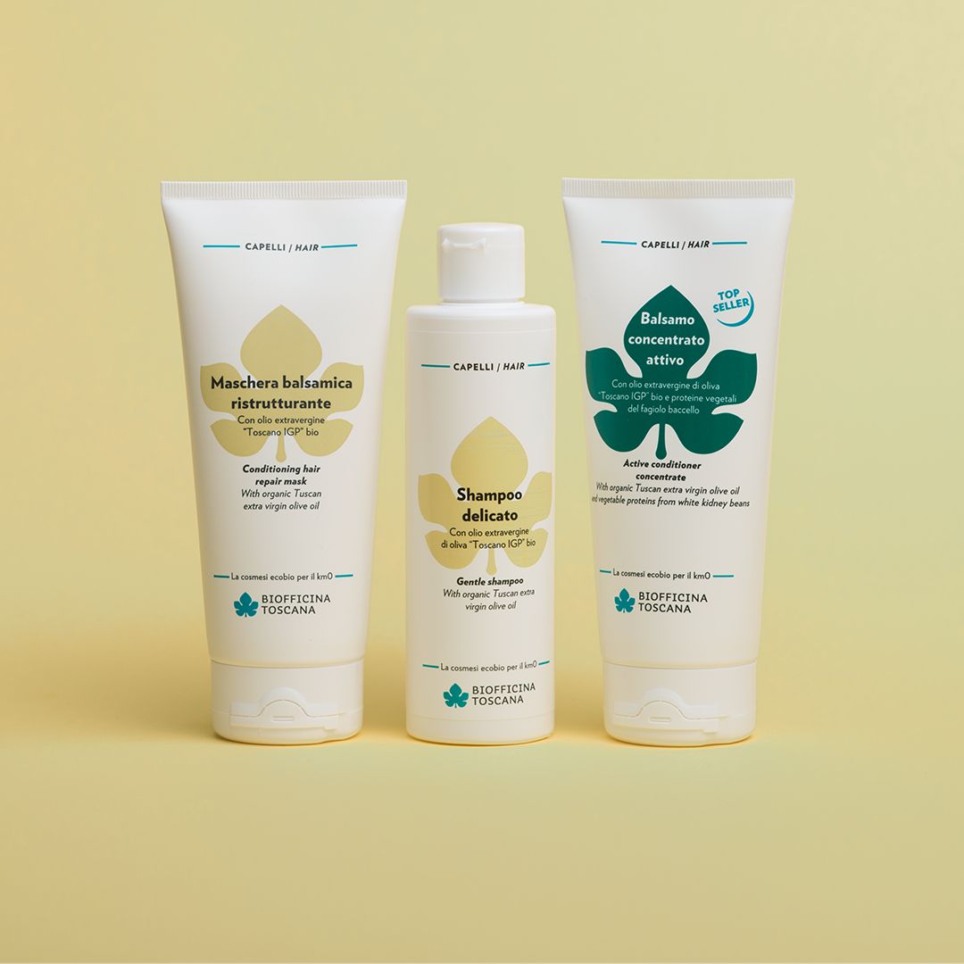 Tre tubi e una bottiglia. Testo: Maschera balsamica ristrutturante, Shampoo delicato, Balsamo concentrato attivo. Logo Biofficina Toscana.