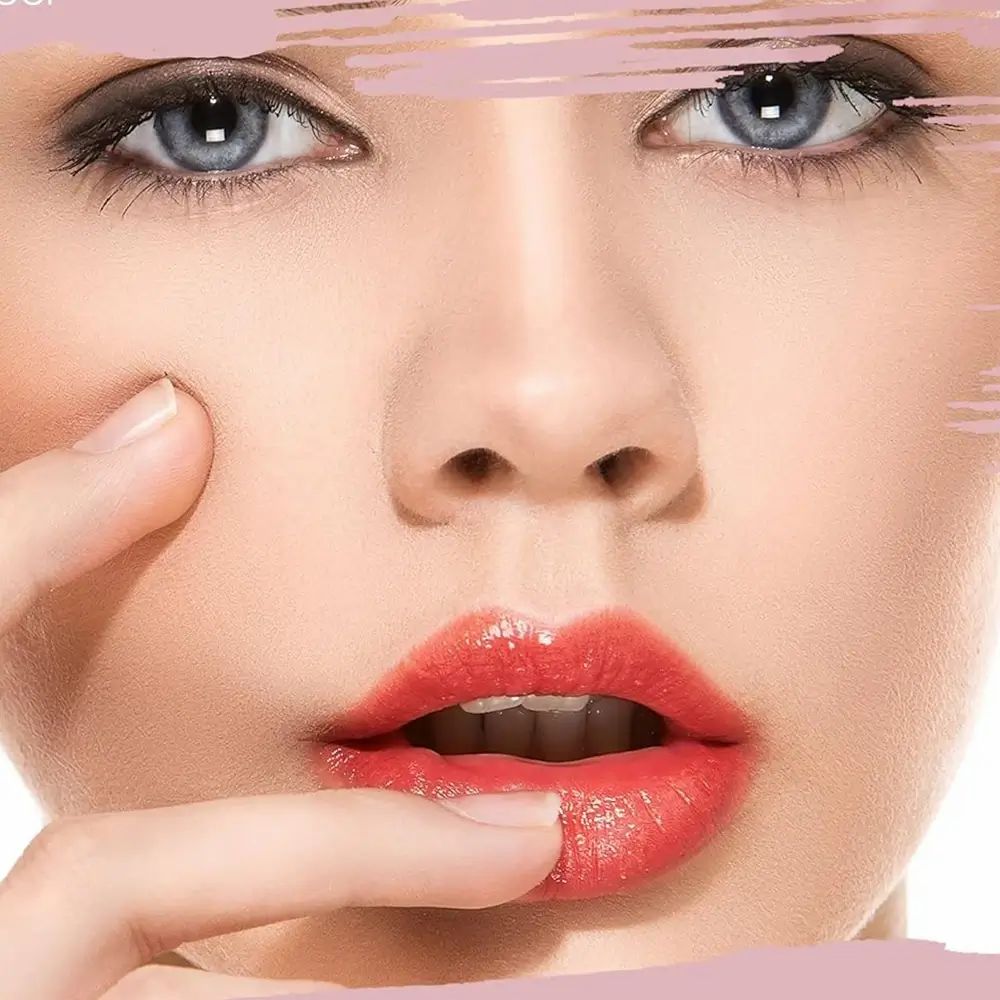 Primo piano di un viso con bocca aperta e rossetto. Un dito tocca il labbro. Gli occhi sono visibili.