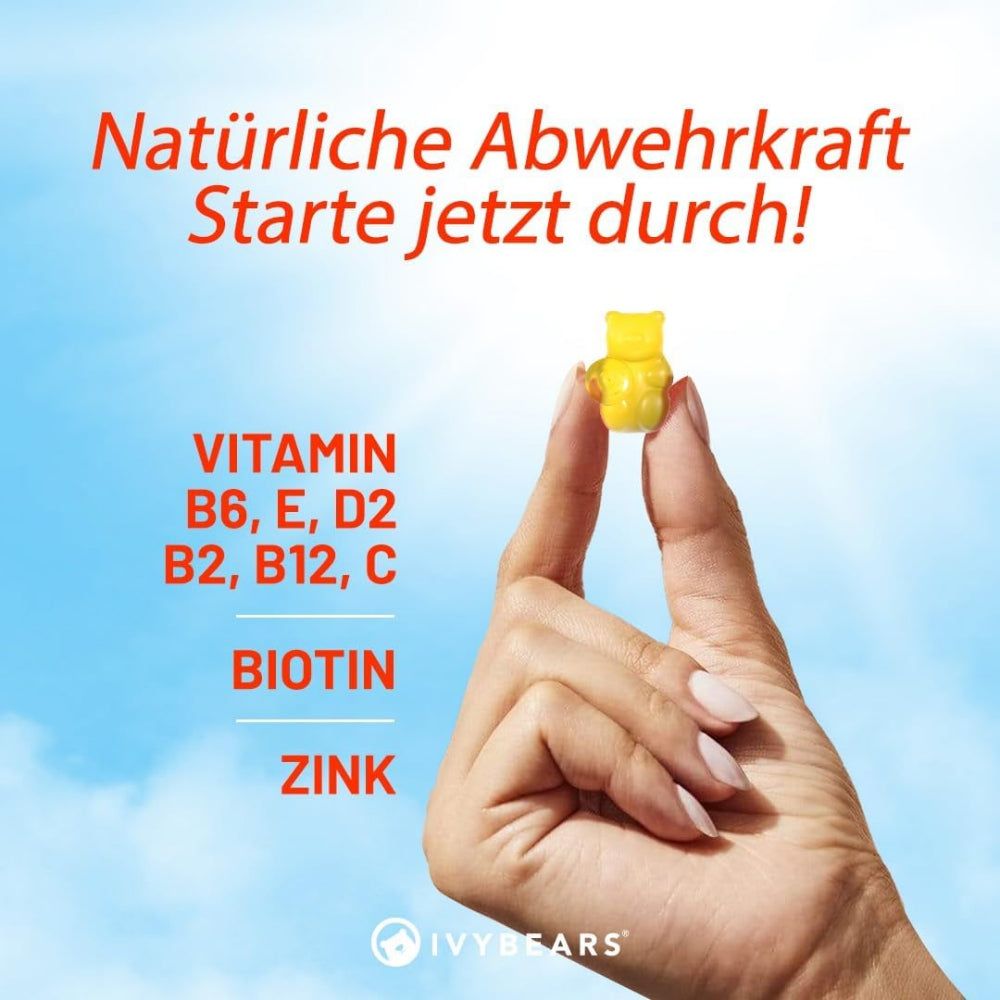 Mano che tiene un orsetto gommoso giallo. Testo: Difese naturali. Entra in azione! Vitamine B6, E, D2, B2, B12, C, Biotina, Zinco.