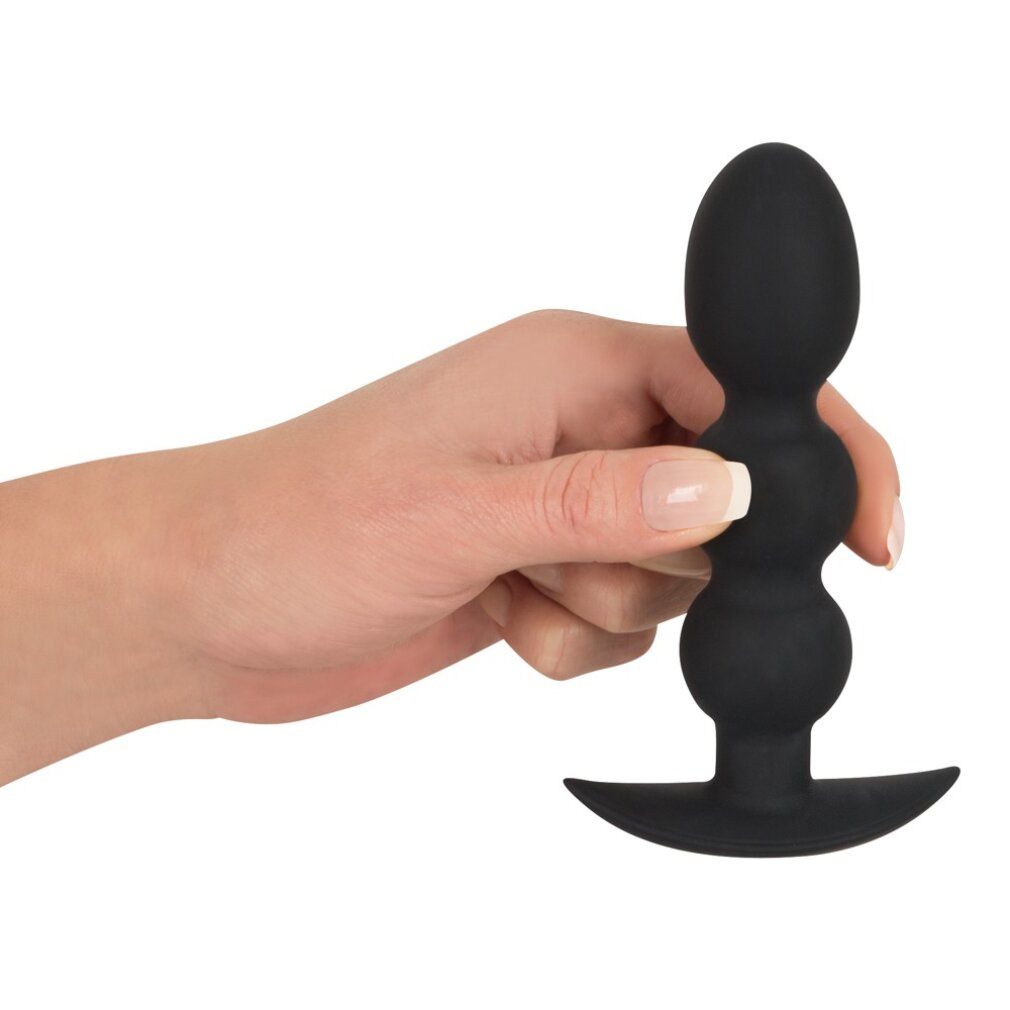 Giocattolo anale nero a tre sfere, tenuto in mano. In silicone.