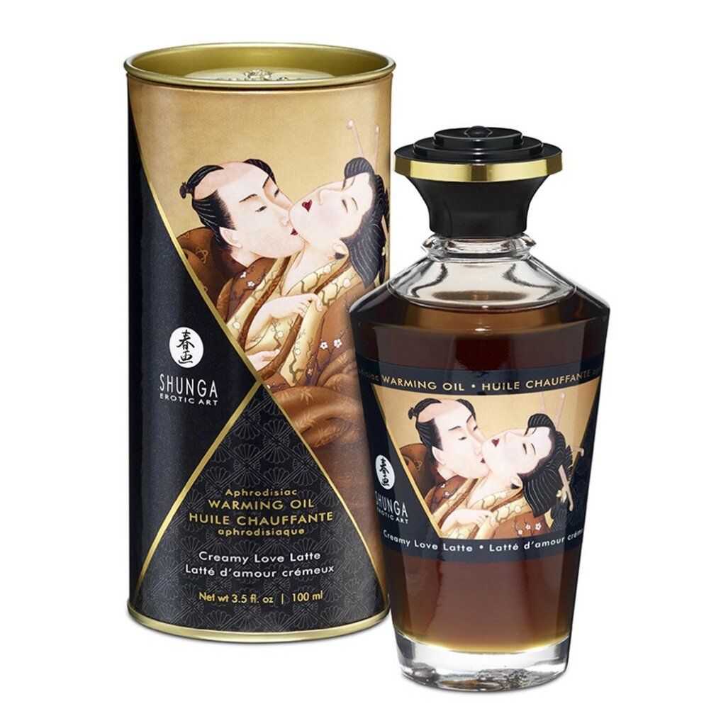 Flacone e scatola con illustrazione. Scritta: Shunga, Warming Oil, Creamy Love Latte. Scatola con design nero e oro.