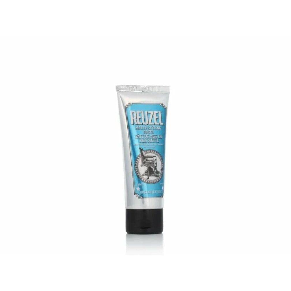 Piccolo tubo d'argento con etichetta blu. Testo: REUZEL, Matte Styling Paste. Immagine di una poltrona da barbiere. 100ml. Prodotto olandese.