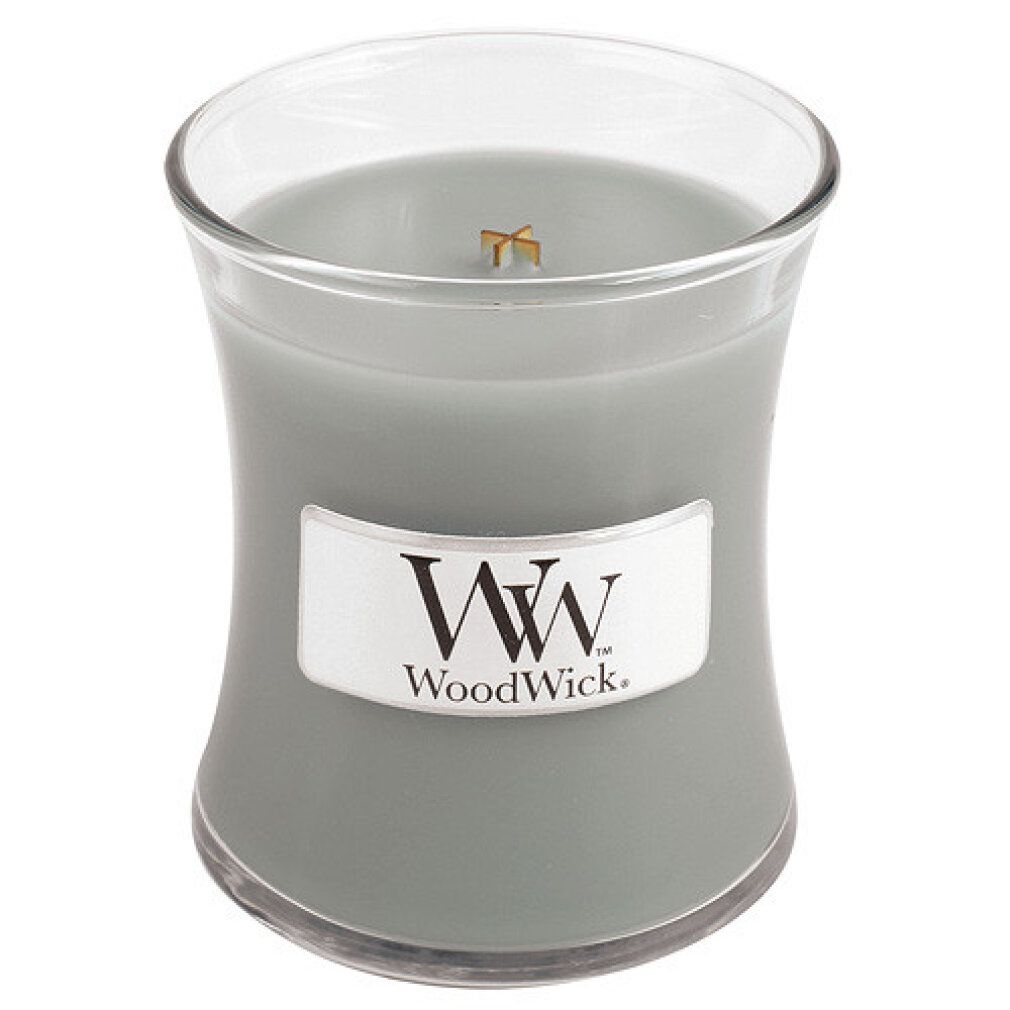 Candela a clessidra grigia senza coperchio. Scritta: WoodWick. Contenitore di vetro.