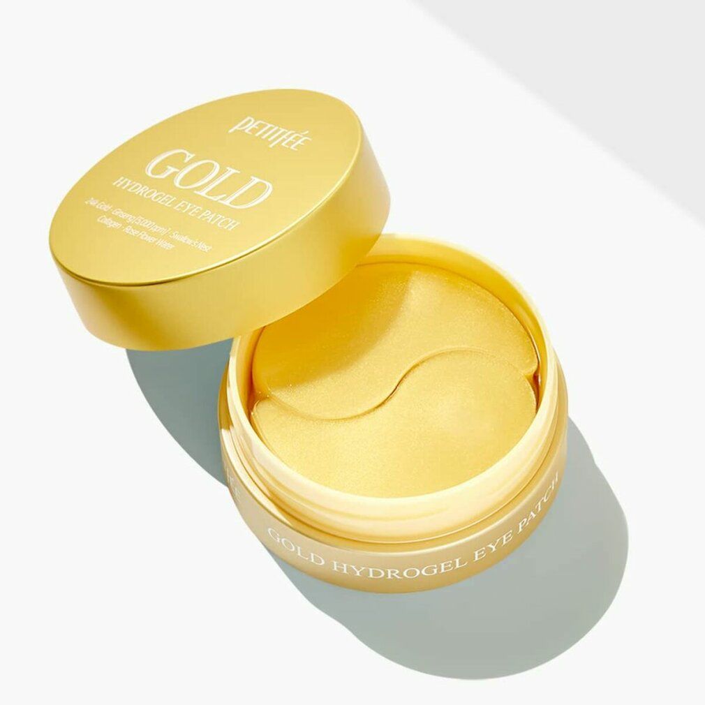 Cerotti per occhi dorati in un contenitore dorato. Coperchio con scritta "GOLD HYDROGEL EYE PATCH". Nome del prodotto visibile.