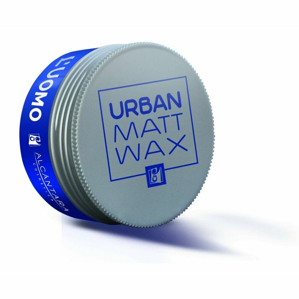 Barattolo rotondo con fascia blu. Scritta "L'UOMO" e "URBAN MATT WAX". Coperchio argentato con testo blu. Marchio Alcántara.