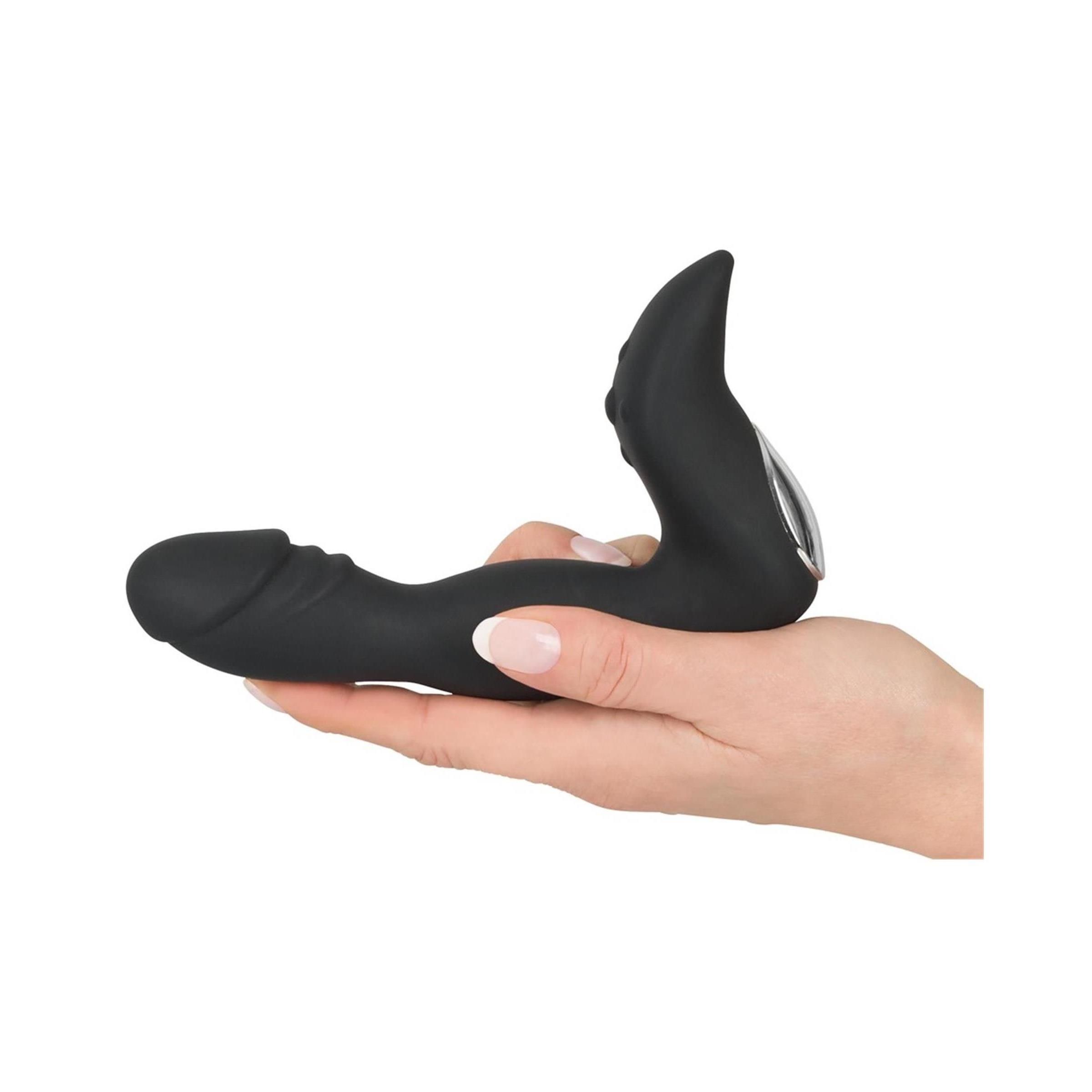 Prodotto benessere nero tenuto in mano. Presenta estremità allungata e asta curva con base.