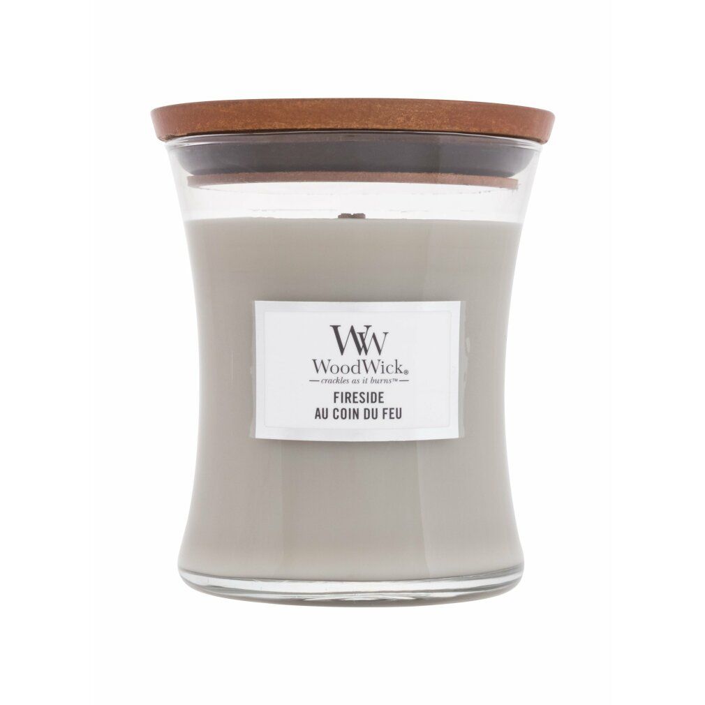 Candela a clessidra con coperchio in legno. Cera grigia, etichetta bianca con logo WoodWick e scritta 'Fireside au coin du feu'.
