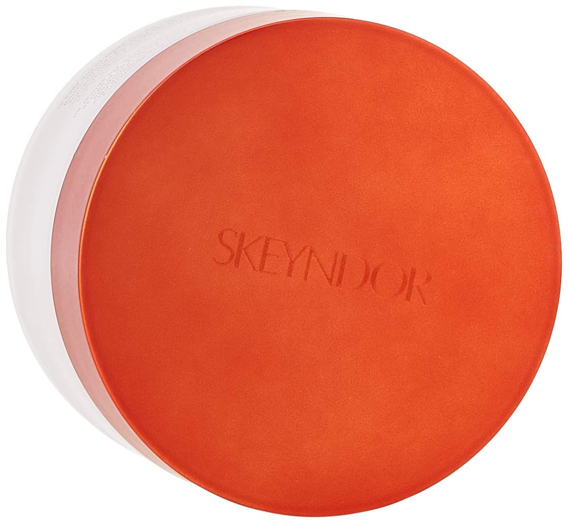 Vista dall'alto di un barattolo di crema con coperchio arancione. Skeyndor è scritto sul coperchio.