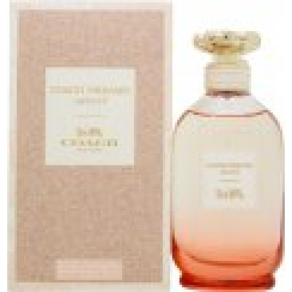 Flacone di profumo accanto alla confezione. Flacone con tappo dorato. Confezione rosa. Scritta: Coach Dreams Sunset.