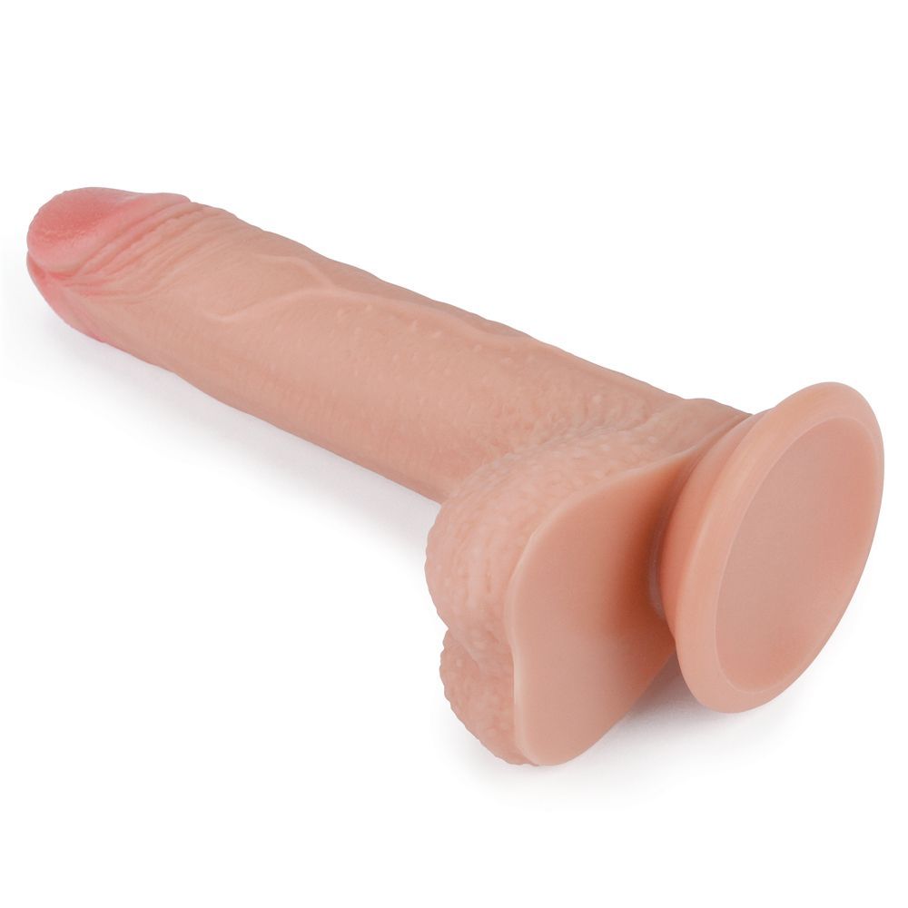 Dildo beige con punta rosa, inclinato. Con base. Su sfondo bianco.
