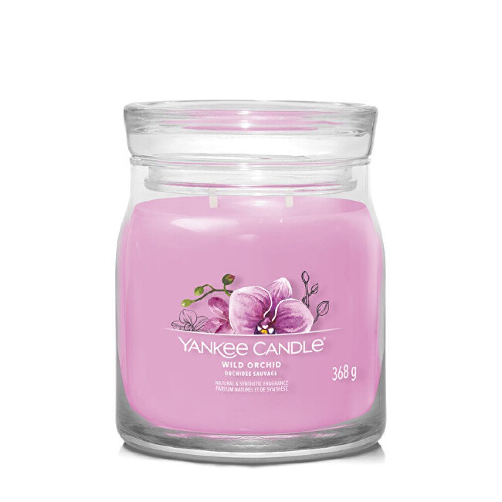 Candela rosa in barattolo con coperchio. Scritta: Yankee Candle Wild Orchid. Illustrazione di un'orchidea. Peso: 368 g.