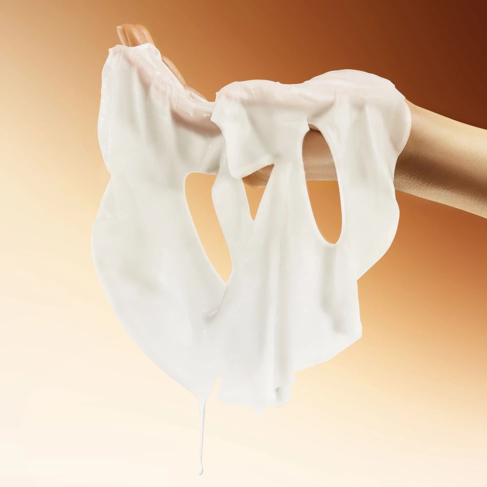 Una maschera per il viso bianca è tenuta da una mano. La maschera ha aperture per occhi e bocca.