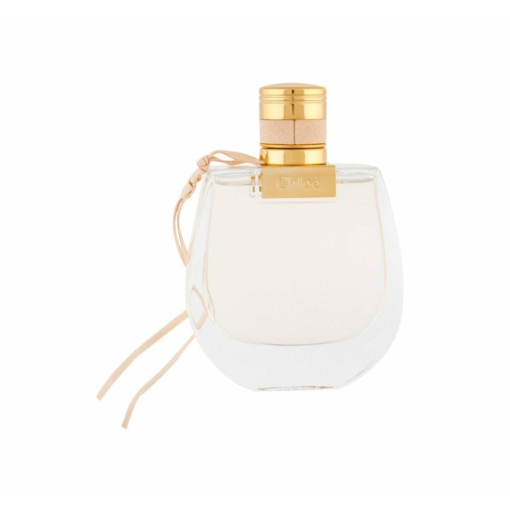 Flacone di profumo con tappo dorato e cinturino in pelle beige. Scritta "NOMADE Eau de Toilette".