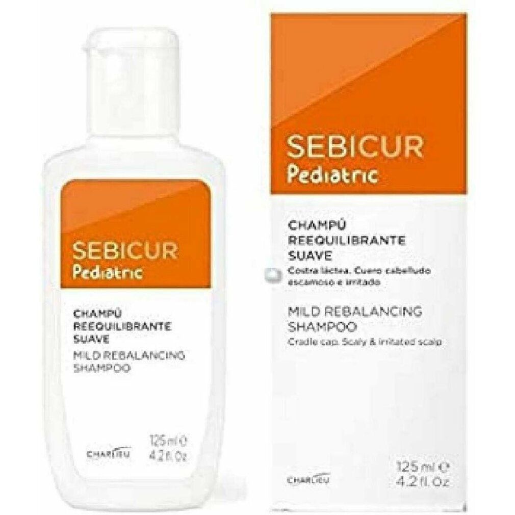 Flacone e scatola bianchi con etichetta arancione. Scritta: Sebicur Pediatric, Champú Reequilibrante Suave, Mild Rebalancing Shampoo.