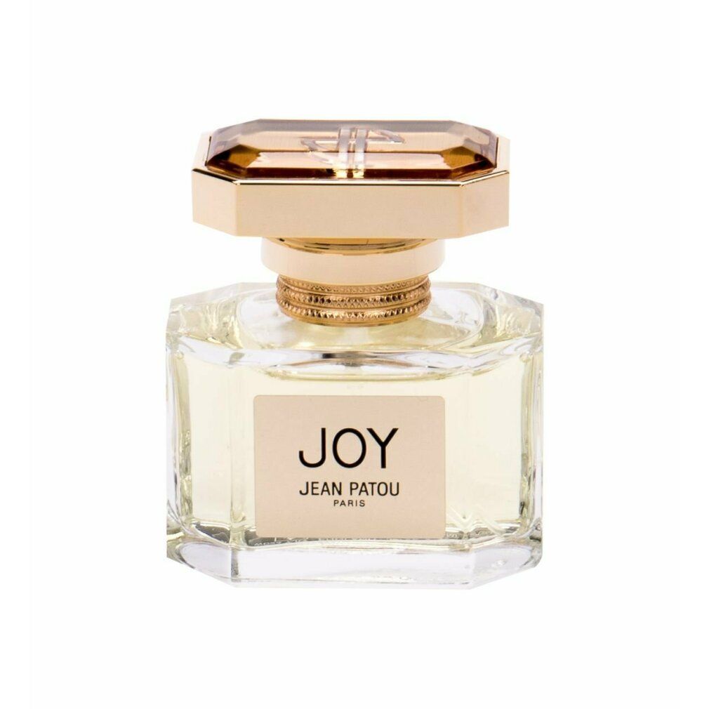 Flacone di profumo con tappo dorato ed etichetta "JOY JEAN PATOU PARIS". Flacone in vetro trasparente con dettagli dorati.