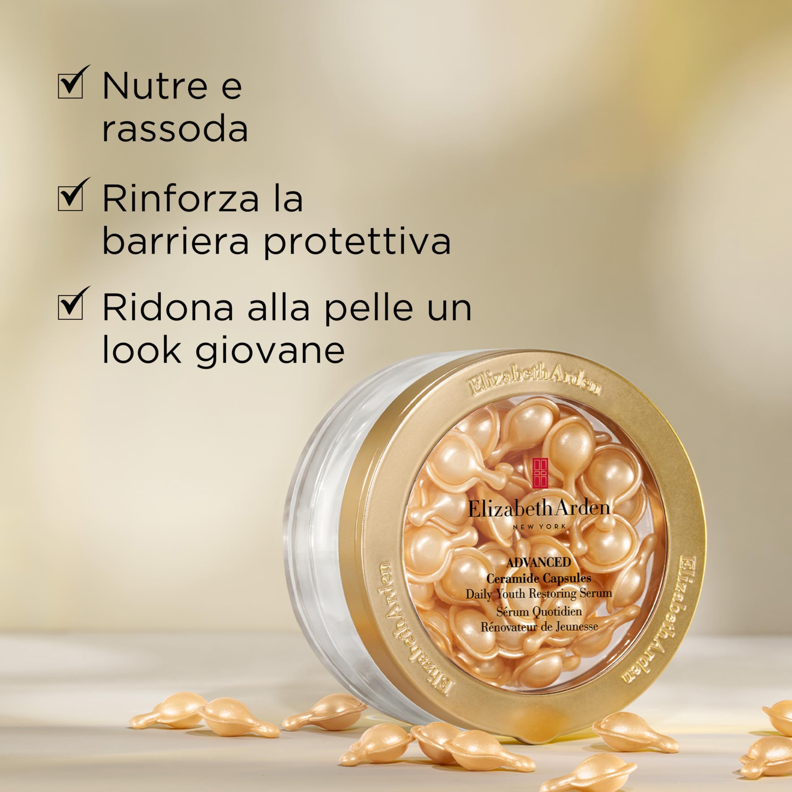 Barattolo dorato con capsule di siero. Scritta: Elizabeth Arden, Advanced Ceramide Capsules, Daily Youth Restoring Serum. Testo in italiano.