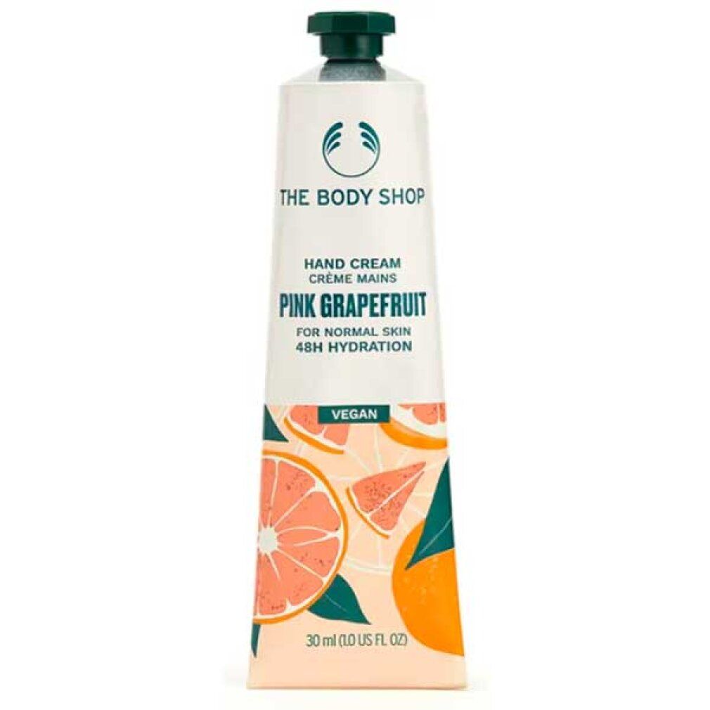 Tubo di crema mani. Bianco, tappo verde. Scritta: Pink Grapefruit, Vegan. Illustrazioni di pompelmo. Marchio: The Body Shop.
