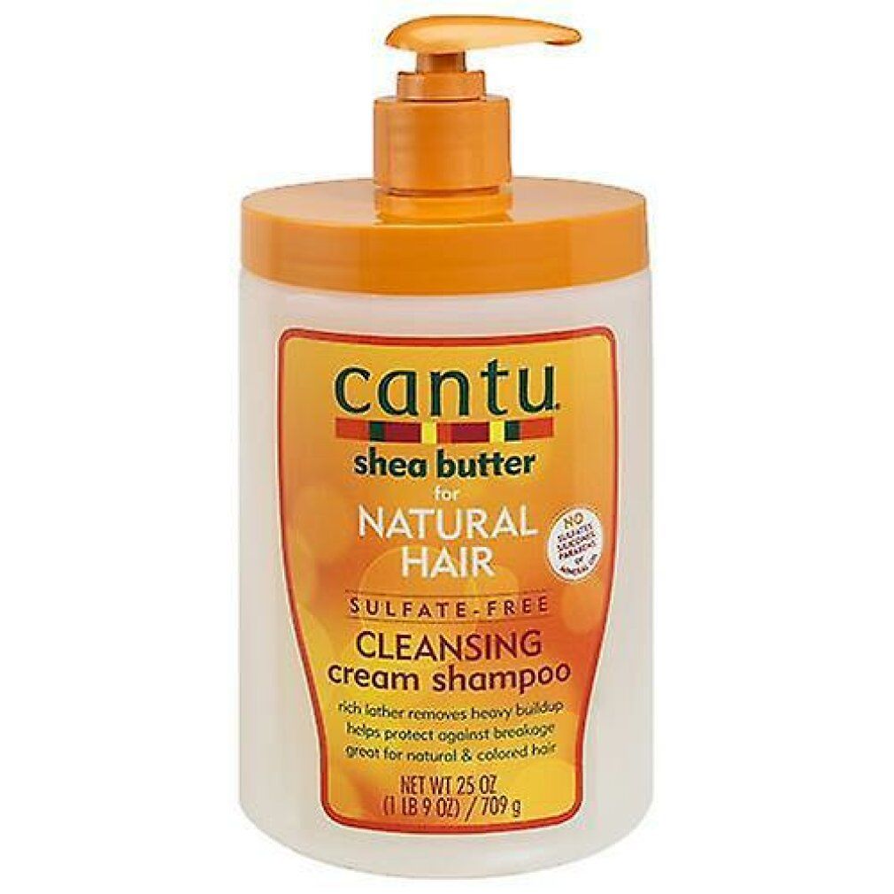 Flacone di shampoo con dosatore a pompa. Scritta: Cantu, Shea Butter, Natural Hair, Cleansing Cream Shampoo. Design arancione e bianco.
