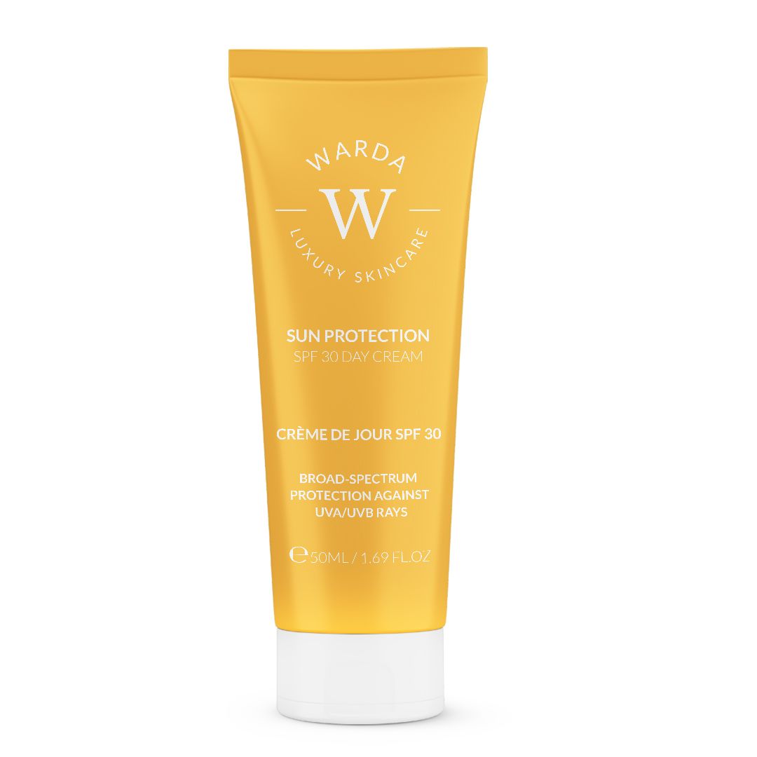 Tubo giallo con tappo bianco. Scritta: Sun Protection SPF 30 Day Cream. Marchio: Warda Luxury Skincare.