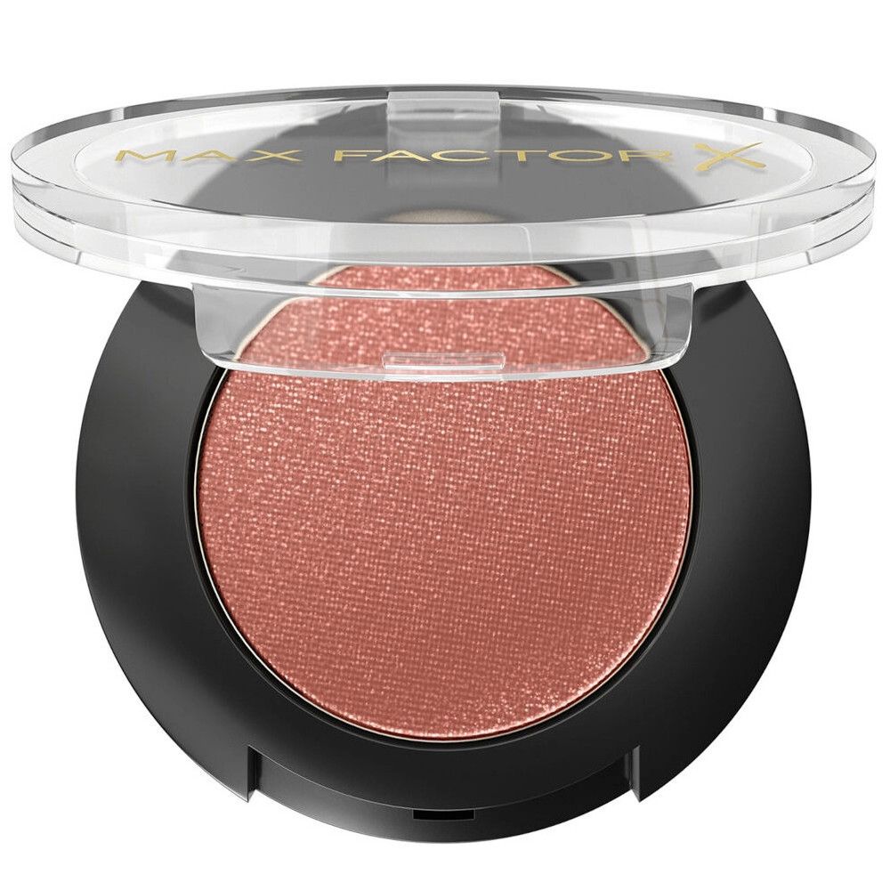Ombretto rosa rotondo in un contenitore nero con coperchio trasparente. Logo Max Factor sul coperchio.