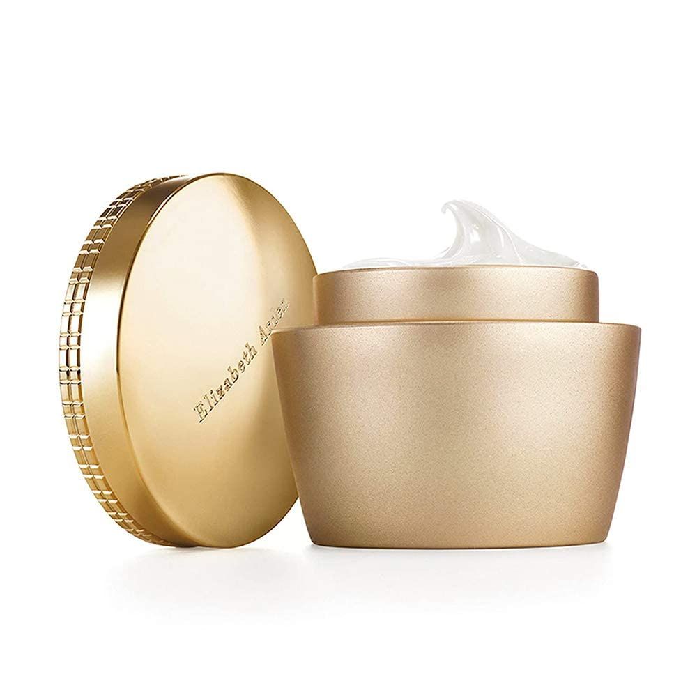Vasetto dorato con coperchio aperto. Il coperchio è accanto. Crema visibile. Elizabeth Arden è scritto sul coperchio.