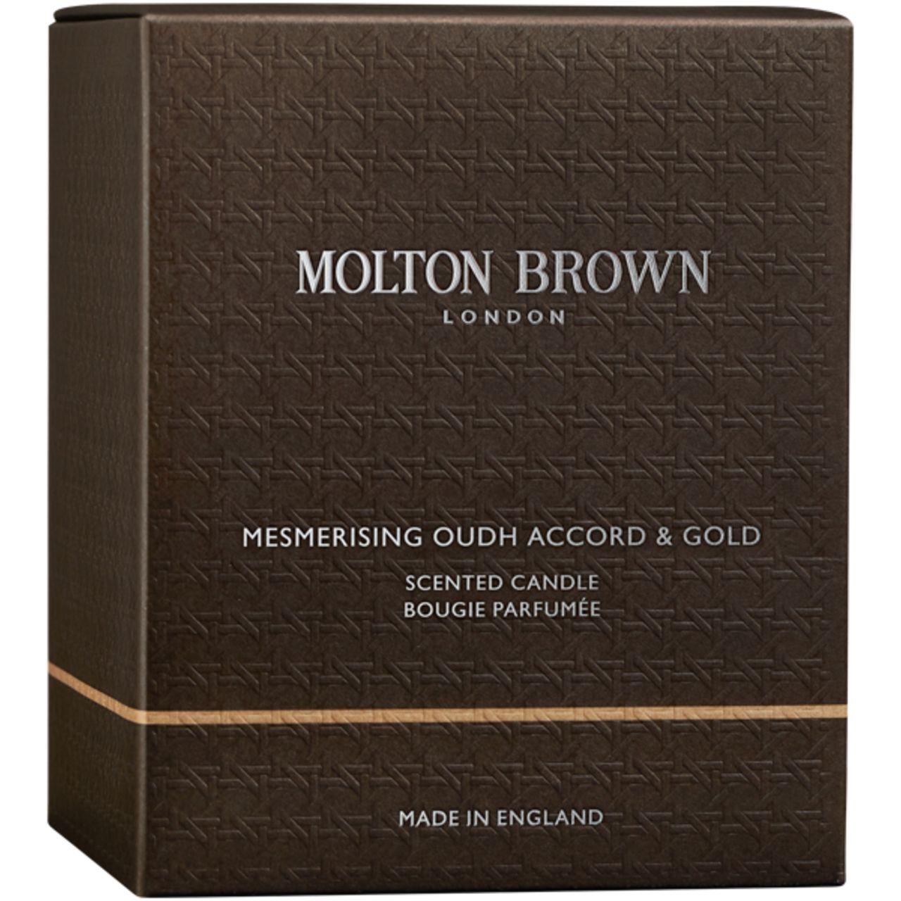Confezione marrone con motivo in rilievo. Scritta: Molton Brown London, Mesmerising Oudh Accord & Gold, Scented Candle, Made in England.