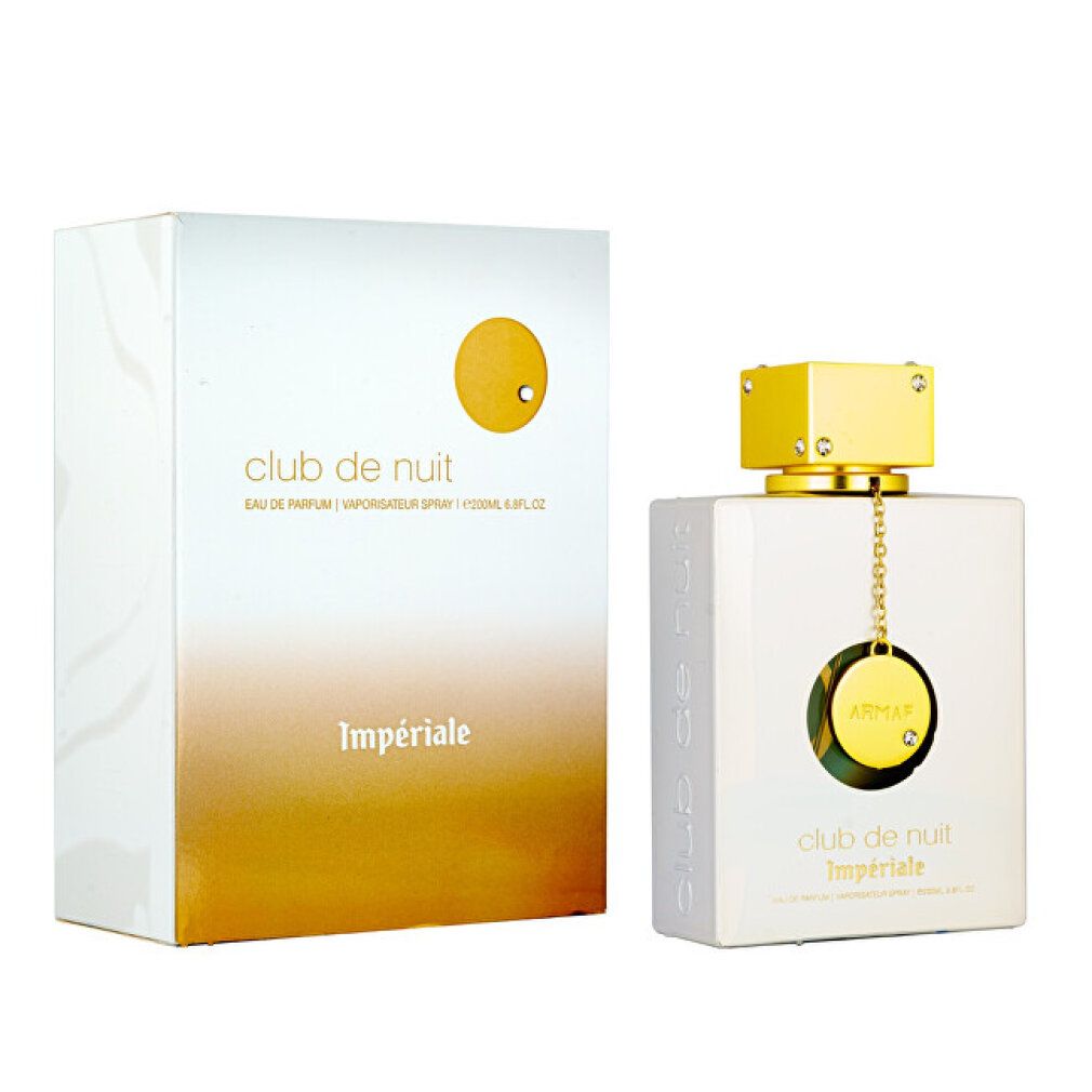 Flacone bianco con tappo e pendente dorati, accanto alla confezione. Nome del prodotto.