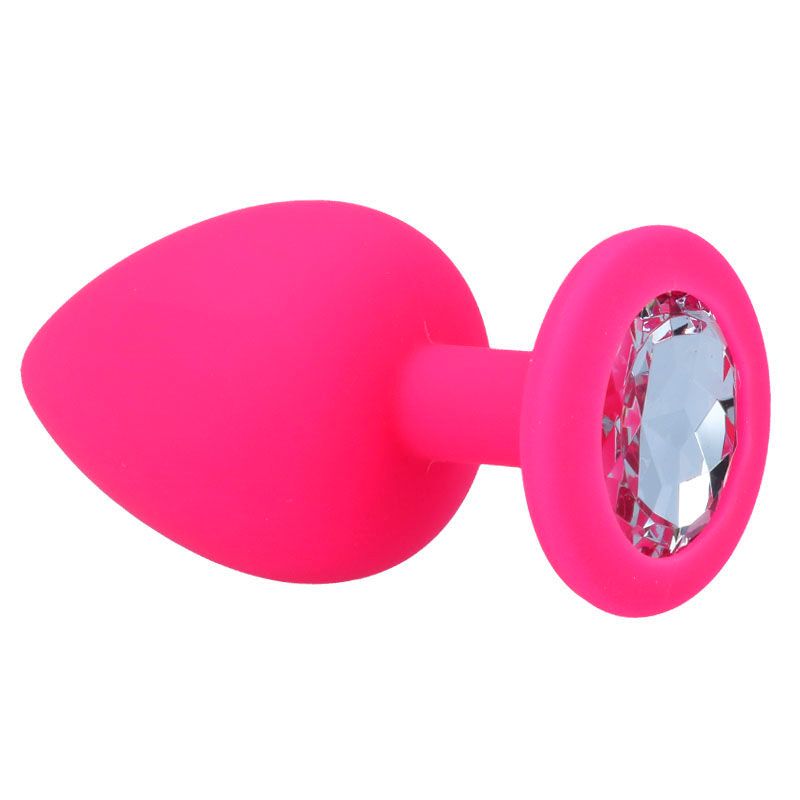Plug anale rosa con decorazione in cristallo. Punta conica, base rotonda con pietra preziosa. Superficie liscia.