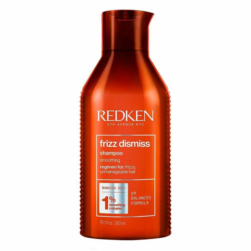 Flacone rosso di shampoo Redken Frizz Dismiss. Testo: Frizz Dismiss, Shampoo, formula pH bilanciata, 1% Smoothing Complex.