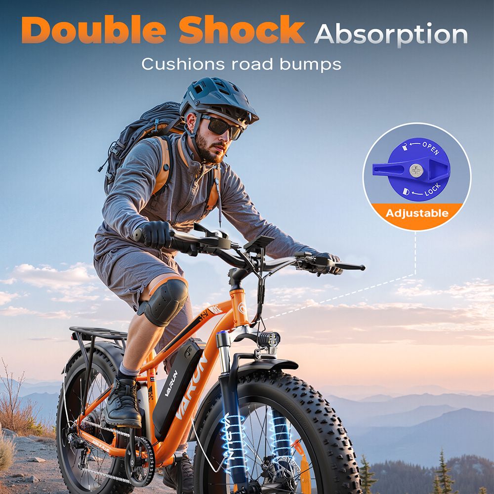 Persona in sella a e-MTB VARUN arancione. Doppio assorbimento degli urti. Sospensione regolabile.