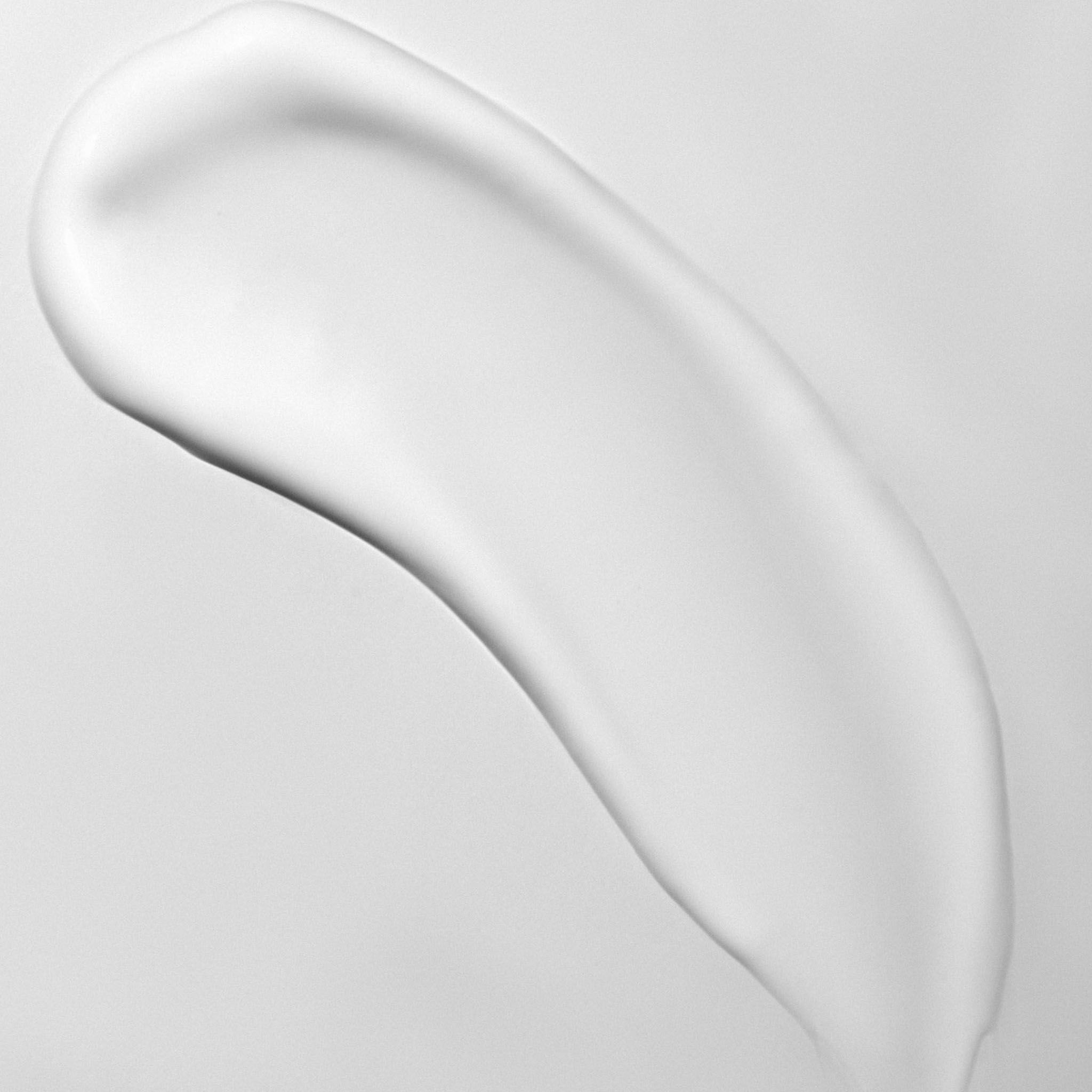 Una striscia di crema bianca su sfondo grigio.