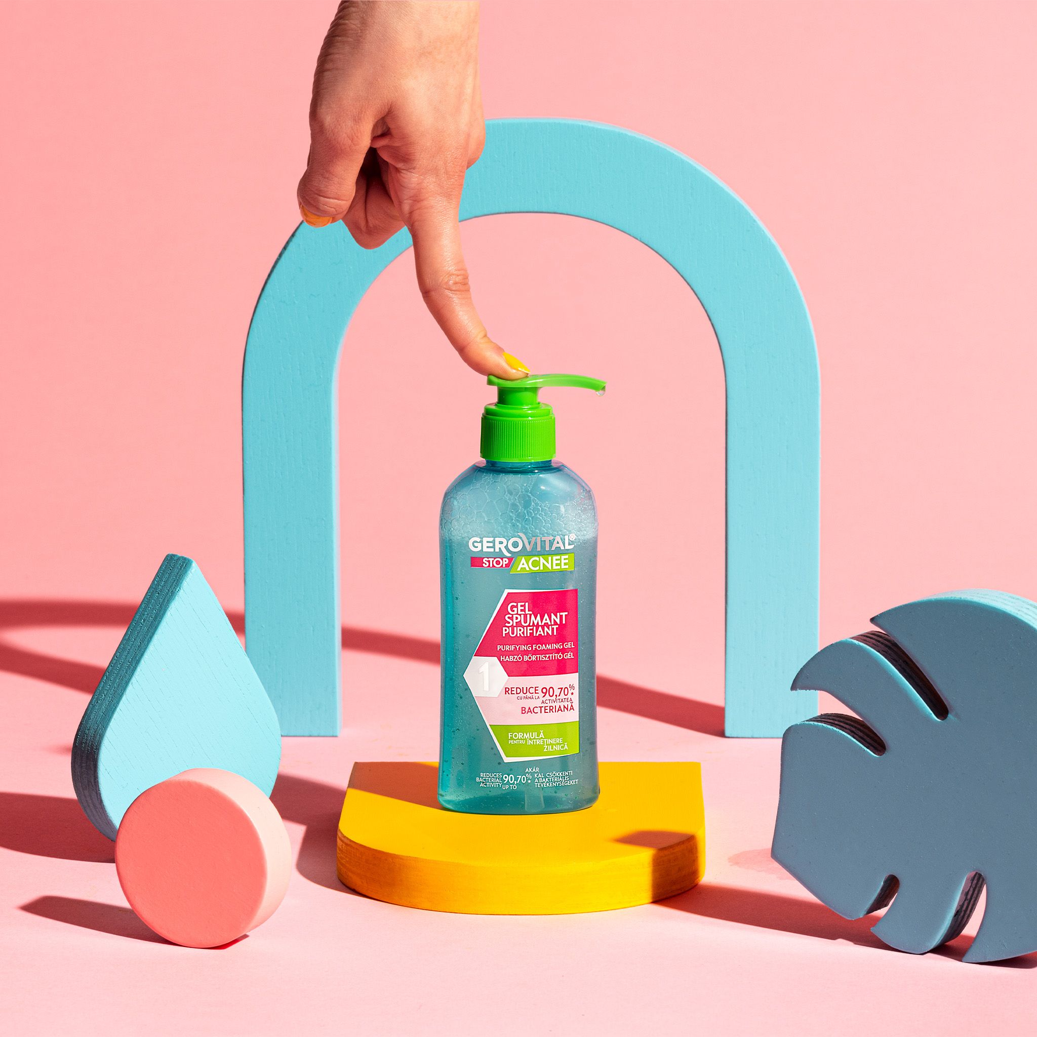 Flacone di prodotto su un piedistallo. Forme decorative. Sfondo rosa.