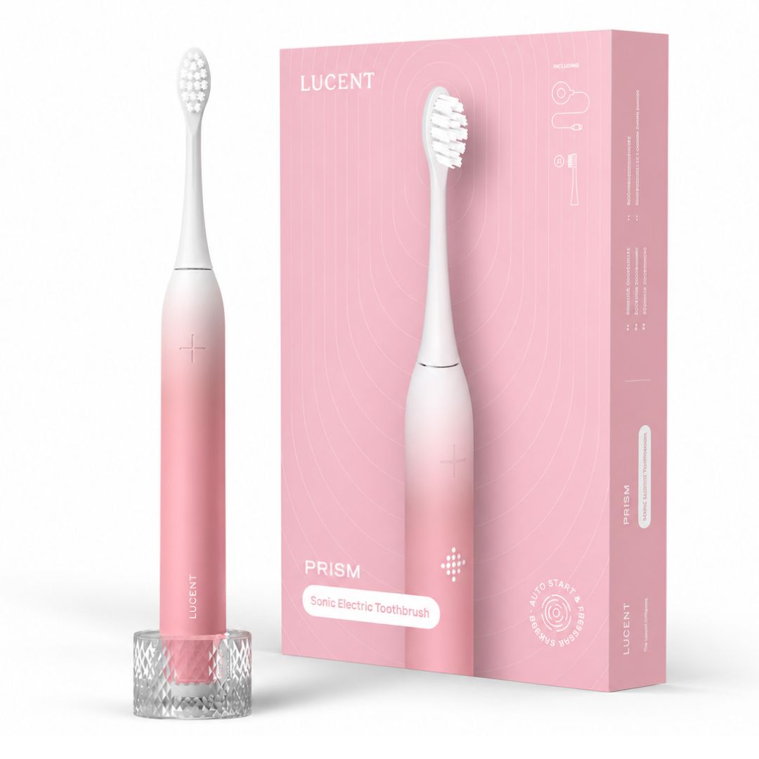 Spazzolino elettrico sonico Be Lucent Prism rosa con supporto di ricarica e confezione.