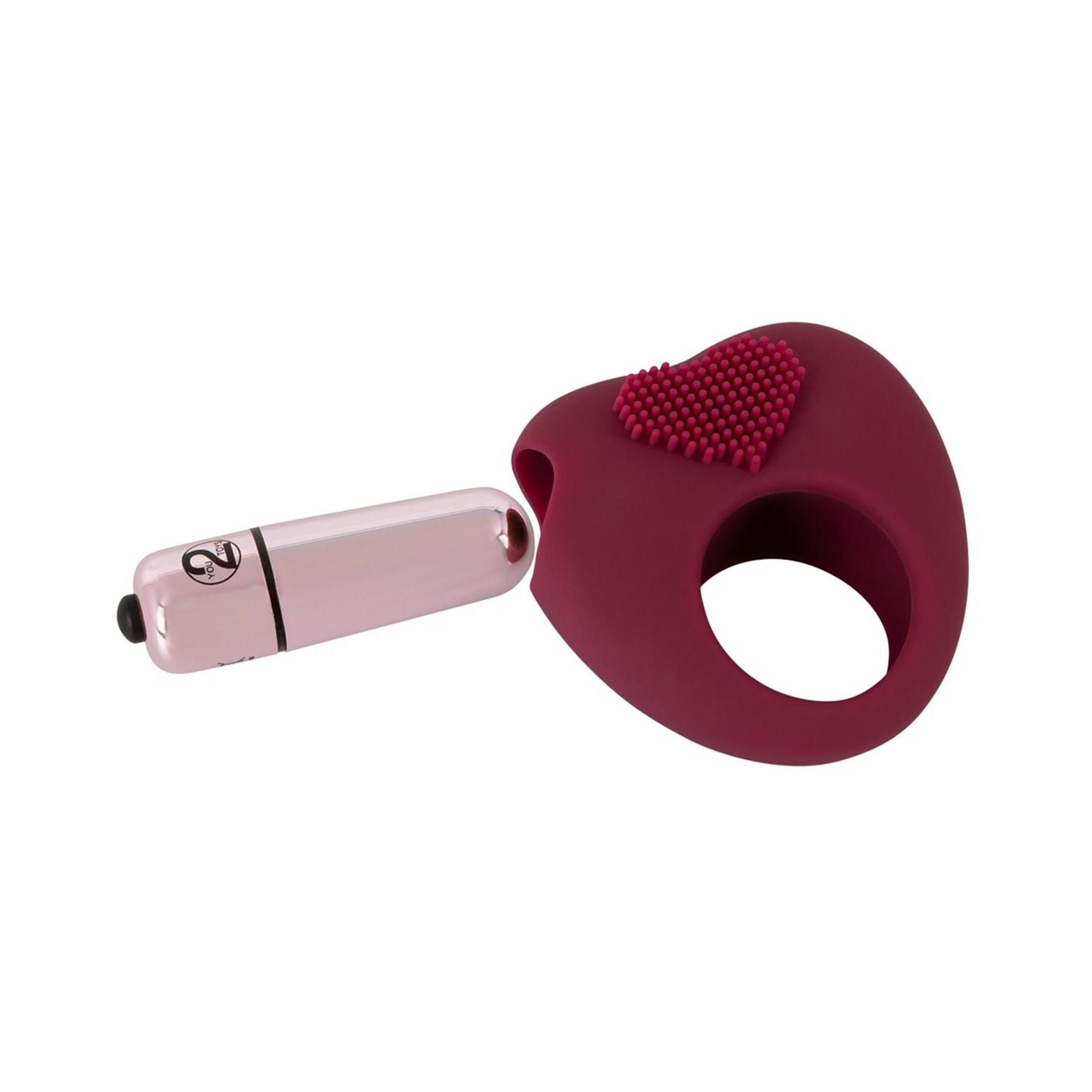 Anello bordeaux con motivo a cuore ed elemento dorato. Pulsante nero. Con vibratore rosa.